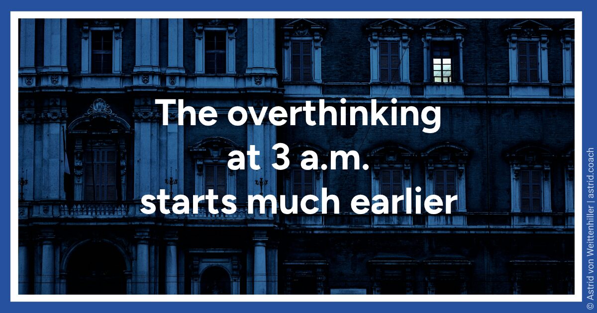 Building facade at night with one lit window.