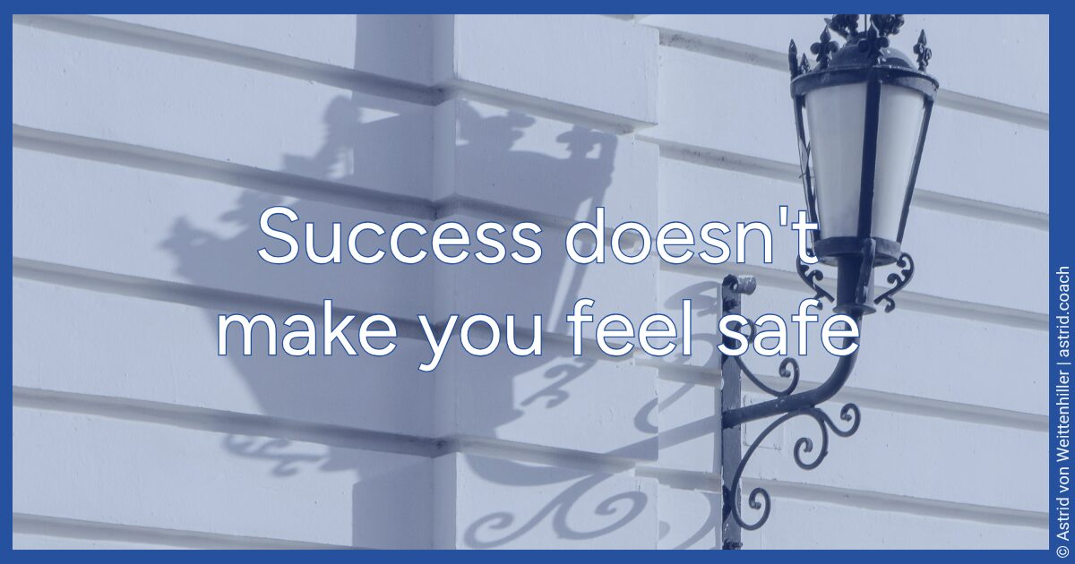 Street lamp against a white building facade with shadow, text overlay: Success was never a reliable anchor